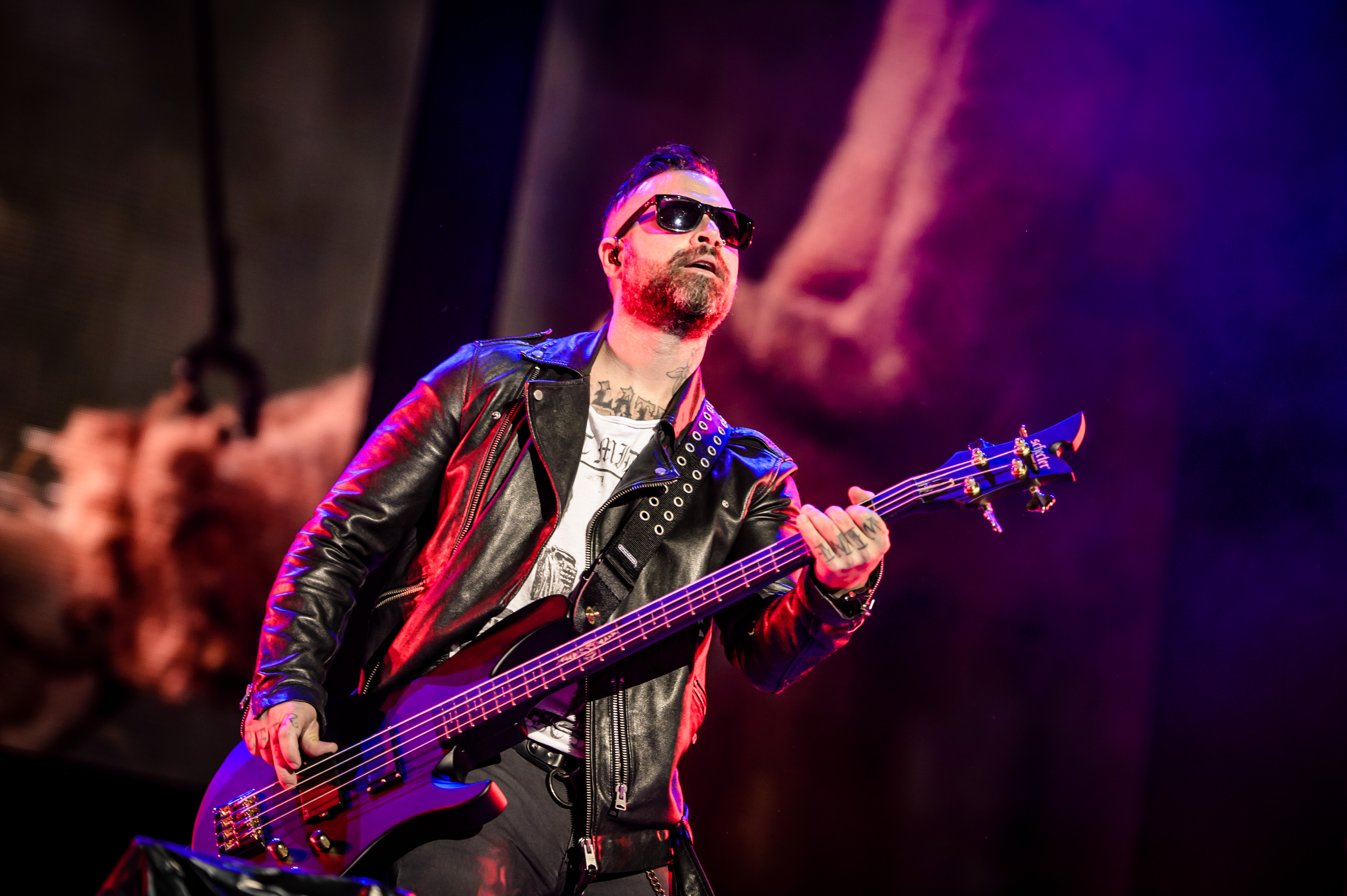 Johnny Christ playing bass live on stage.